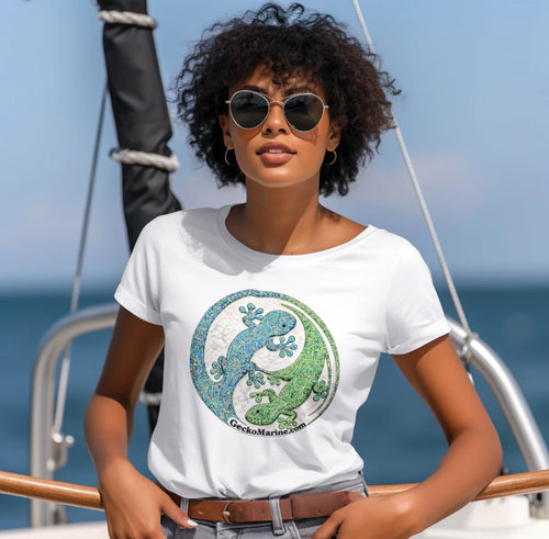 Woman wearing a white t-shirt with a gecko graphic on a sailboat